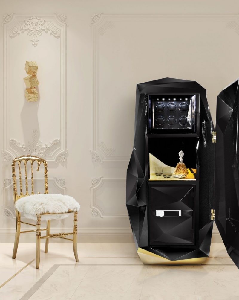 California Home Decor - luxurious black safe, gold chair and white fur, white walls and gold lamp 