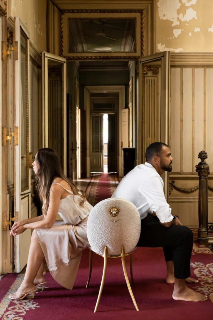 intimate luxury - hallway in brown tones with red rug and cream chair with gold details 