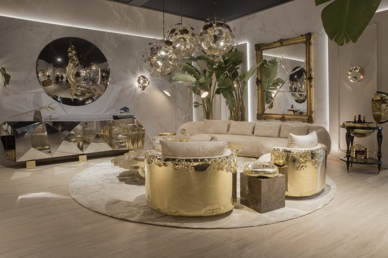 living room with light and gold sofa, shiny silver furniture, background plants and two mirrors