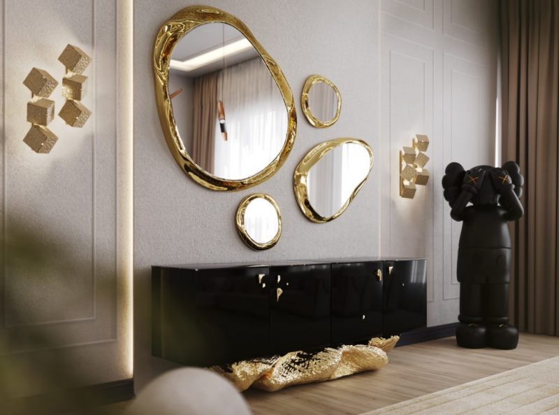 Angra Collection- hallway with gold wall lamps, black mickey statue, black luxury sideboard with gold base, gold oval mirrors 