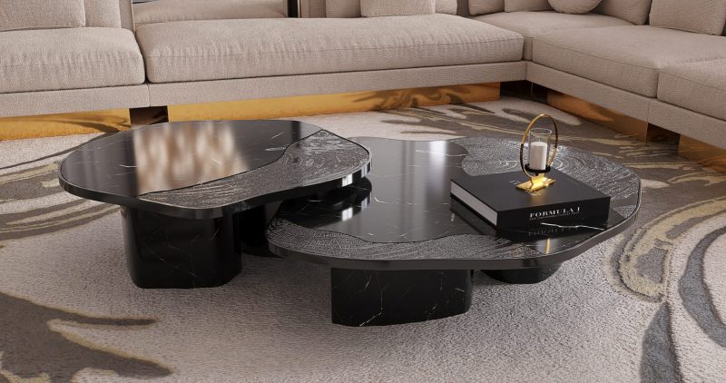 Ophelia Center Table- black coffee table with a book and a candle, a rug and a cream and gold sofa 