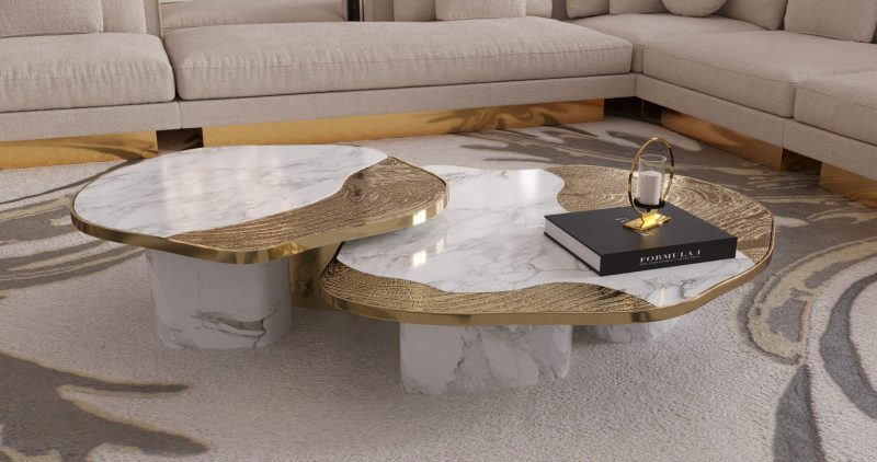 Ophelia Center Table - marble and gold center table, a book, a rug and a cream and gold sofa 