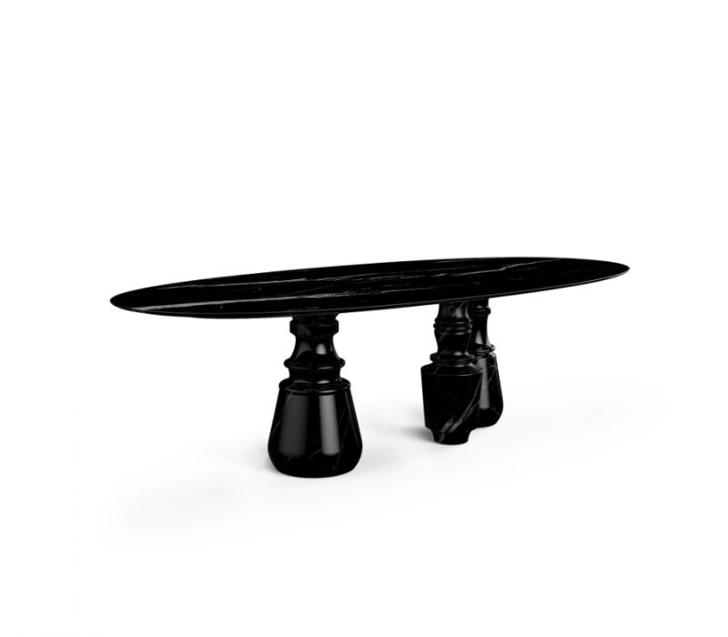 luxury villa - black marble dining tabel with oval top gently lies in three robust marble columns